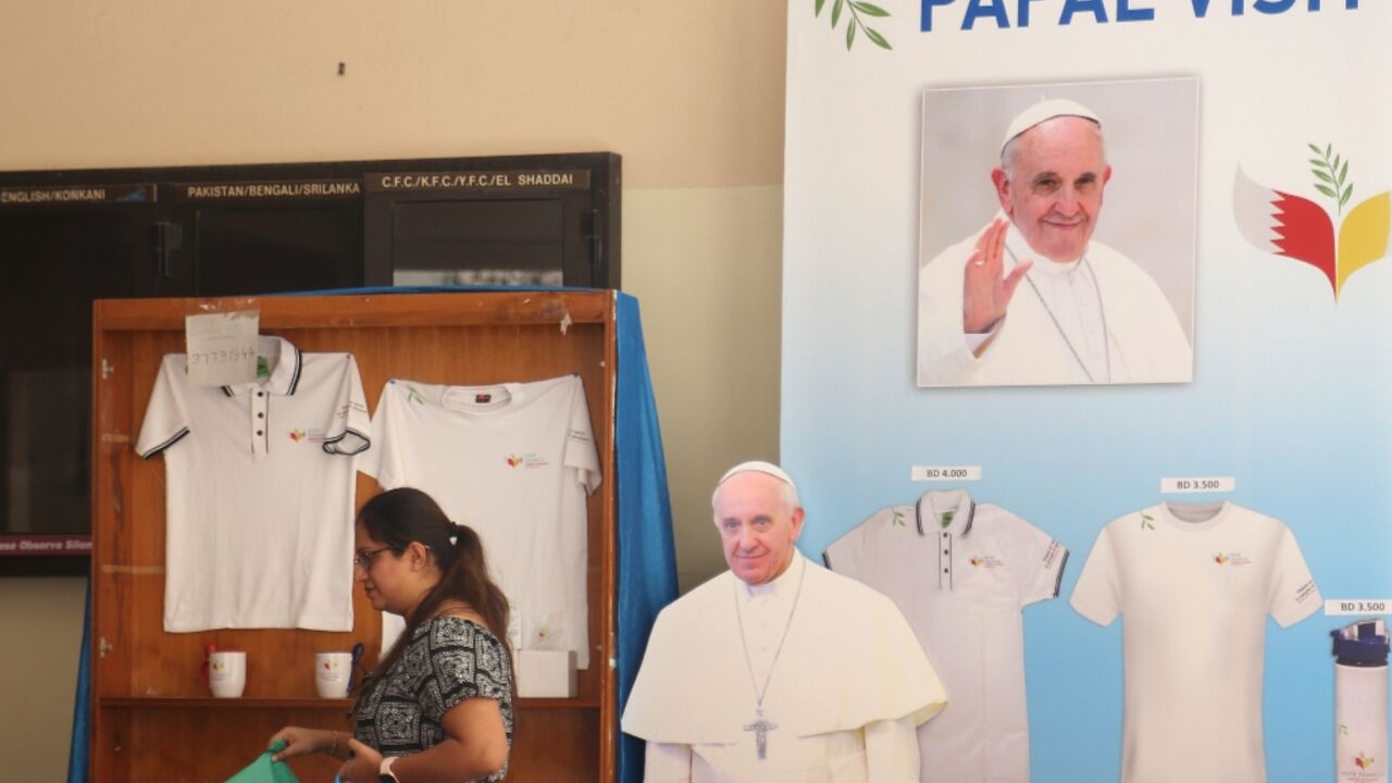 A woman walks past a cutout image of Pope Francis in Bahrain's capital Manama A woman walks past a cutout image of Pope Francis in Bahrain's capital Manama