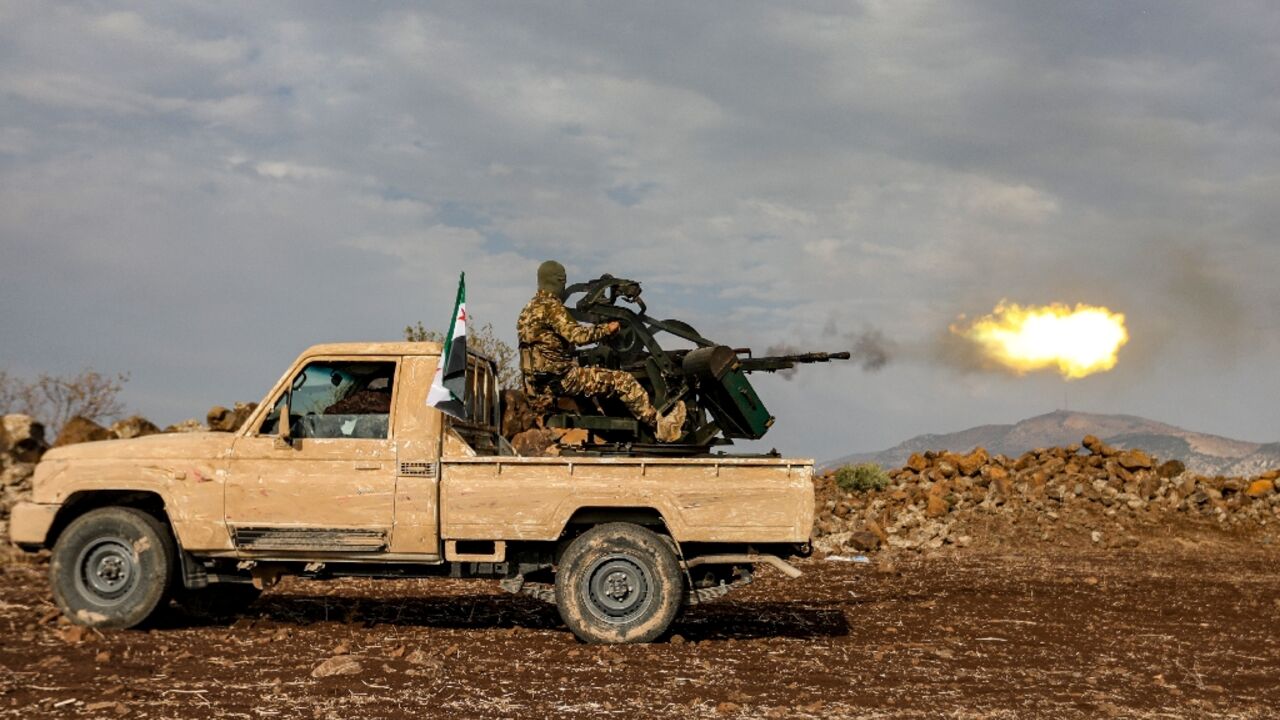 A Syrian fighter opens fire during drills by a Turkish-backed division in northern Syria
A Syrian fighter opens fire during drills by a Turkish-backed division in northern Syria