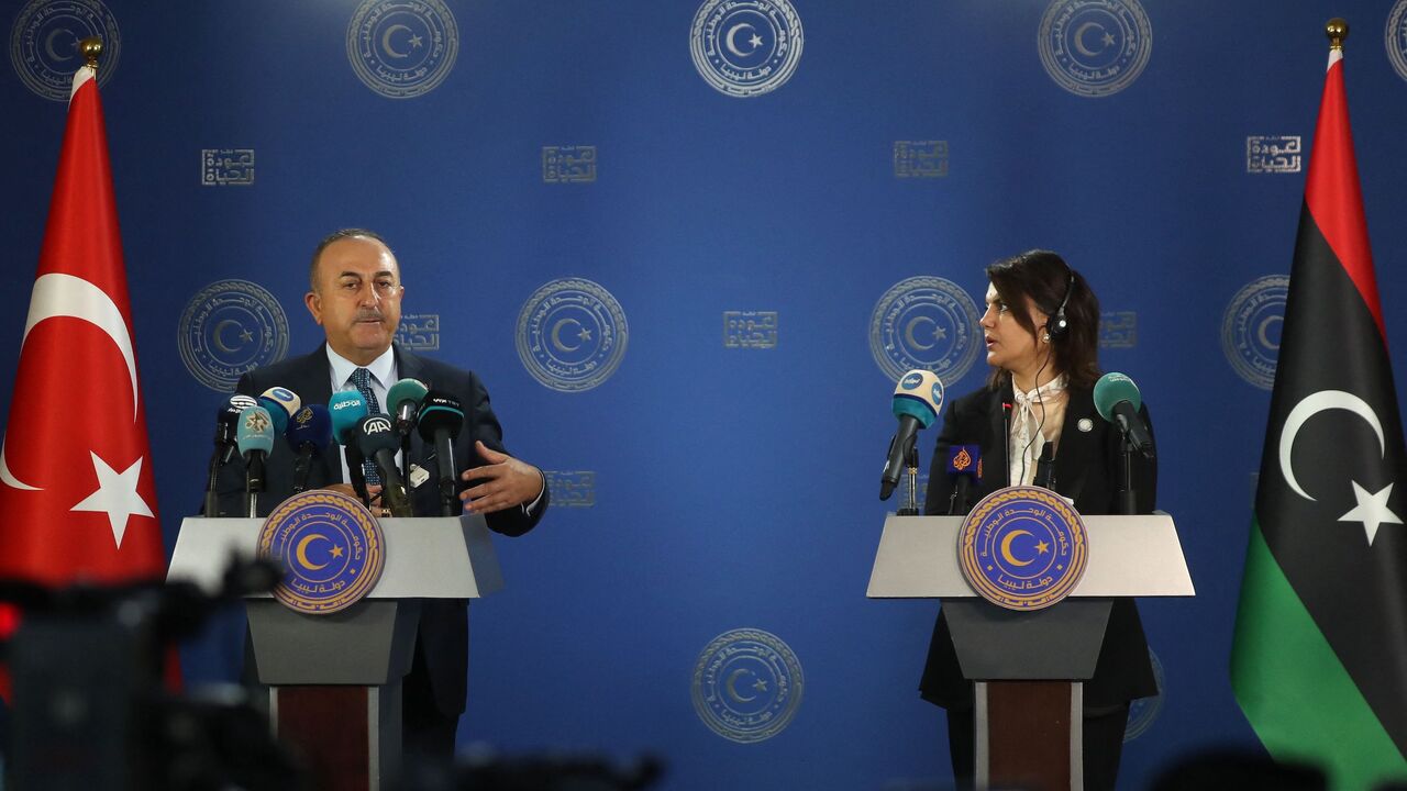 Libyan Foreign Minister Najla al-Mangoush (R) and Turkish Foreign Minister Mevlut Cavusoglu.