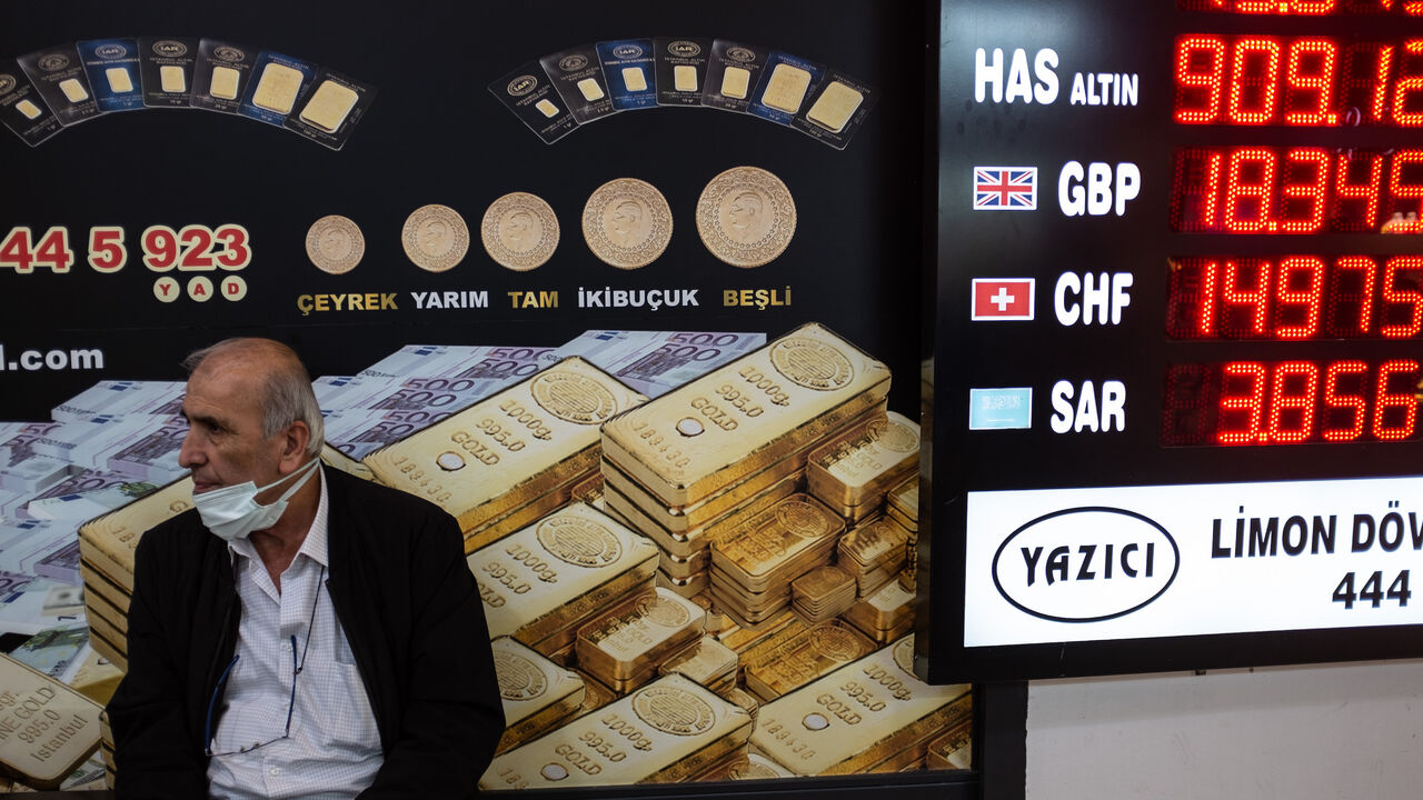 A man sits next to a currency exchange office at Istanbul's Grand Bazaar on May 5, 2022.