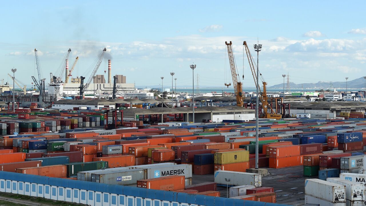 Cranes and containers are pictured on November 12, 2014, in the Tunisian port city of Rades. The World Bank said in a report published last September that Tunisia's economic model of manufacturing for exports and protecting the domestic market was valid in the 1970s but since then had hindered progress. AFP PHOTO / FETHI BELAID (Photo credit should read FETHI BELAID/AFP via Getty Images)