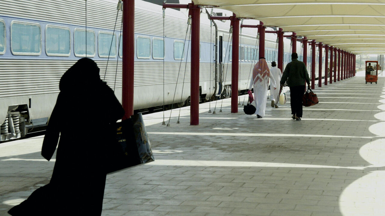 Saudi passengers take the train on an internal trip in Riyadh's only railway station 19 September 2004. Only four passenger trains per day operate from the six-platform station and along the sole operating track in the vast desert kingdom. The trains carried around 900,000 passengers in 2003 between the capital -- home to some four million -- and the center of the oil-rich Eastern Province. The Saudi Railways Organization (SRO) believes that the existing service has improved immensely during the past three 