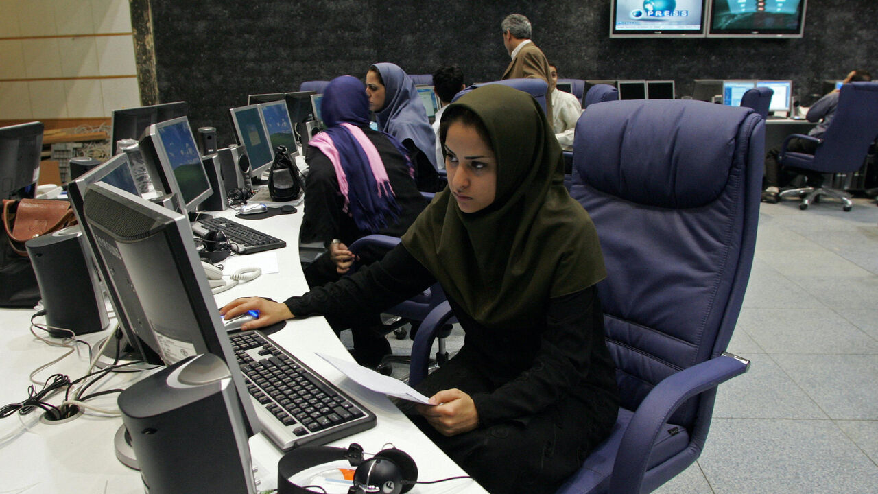 Tehran, IRAN: TO GO WITH AFP STORY BY FARHAD POULADI: Iranian staff members of "Press TV" news channel work at the newsroom in Tehran, 20 June 2007. An increasingly crowded market for 24-hour news is facing a new rival -- a channel from Iran whose self-proclaimed aim is to break the "stranglehold" of the West over the world?s media. Iran's state broadcaster is to launch "Press TV" on July 2 at a time of mounting international tension over its nuclear programme, complete with international journalists brough