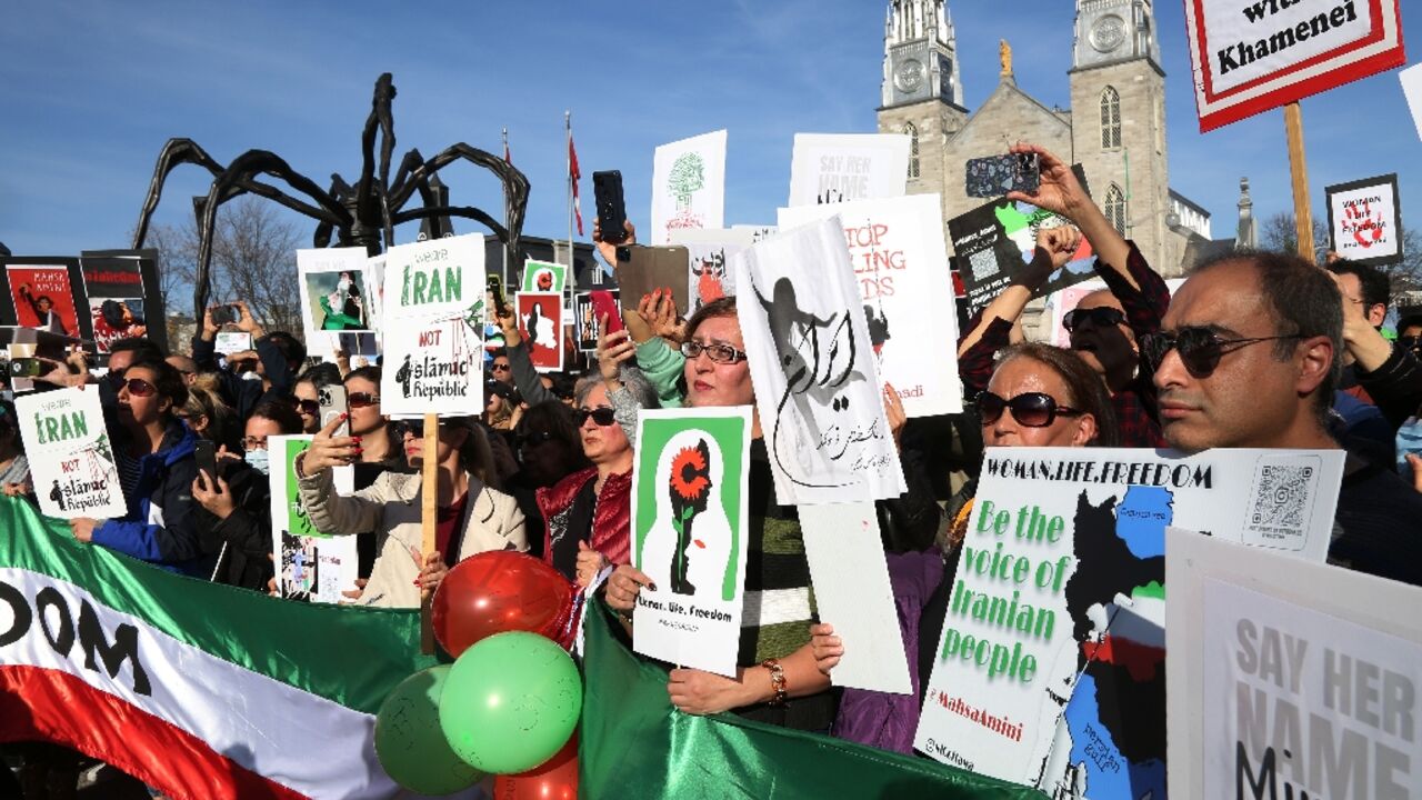 People rally in downtown Ottawa, Canada, in support of freedom for women in Iran in October