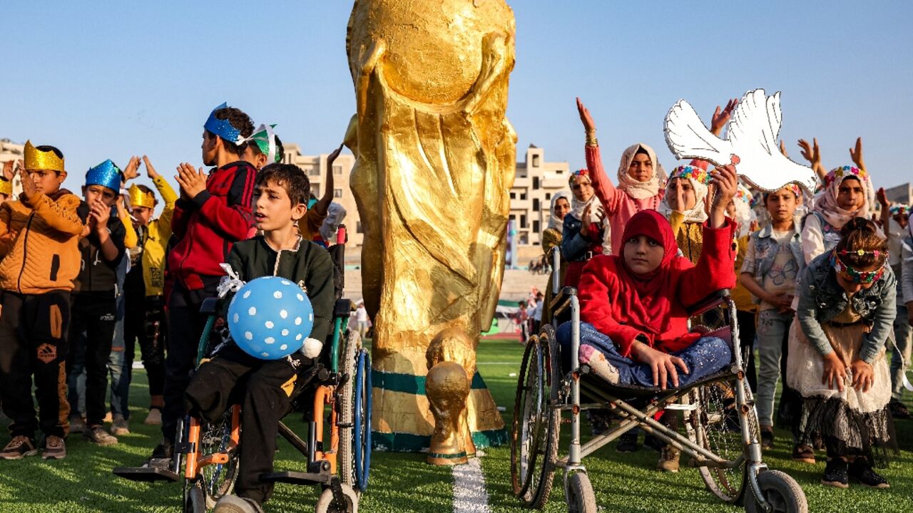 Syrian children take part in the opening ceremony of their own 'camps World Cup' tournament at the municipal stadium in Idlib Syrian children take part in the opening ceremony of their own 'camps World Cup' tournament at the municipal stadium in Idlib