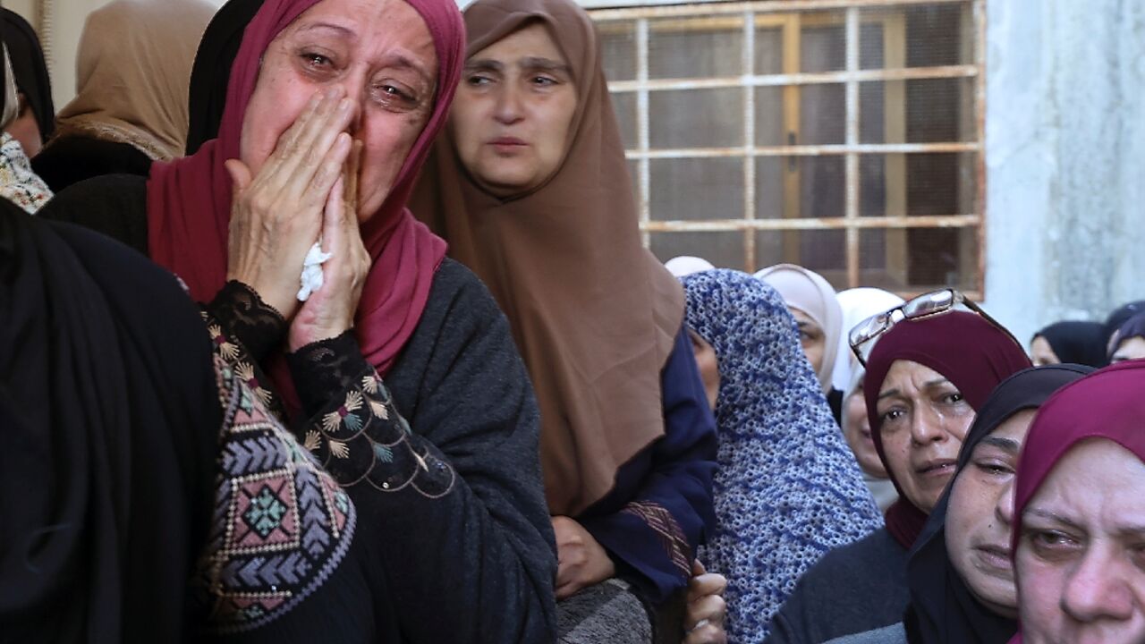 Palestinian mourners cry during the funeral of militant Muhammad Ayman al-Saadi, 26 Palestinian mourners cry during the funeral of militant Muhammad Ayman al-Saadi, 26
