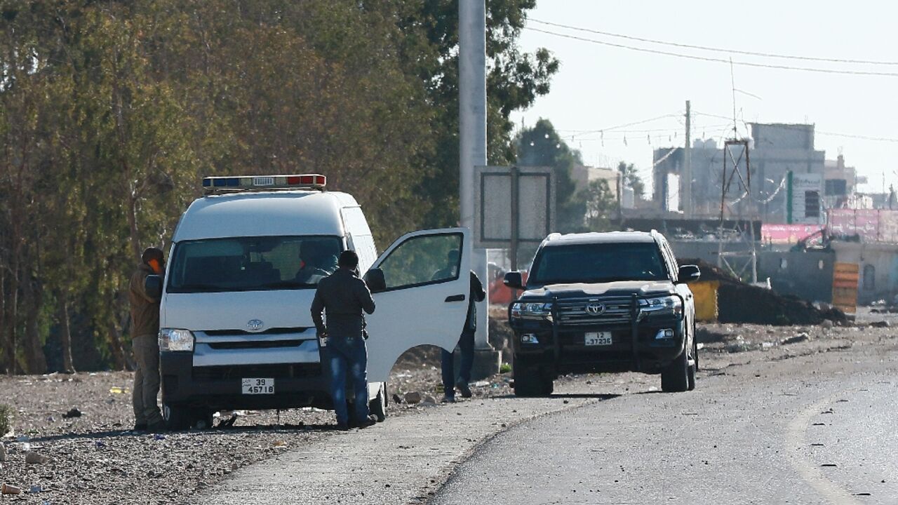 A forensic team collects evidence in Maan, Jordan,  after a senior police officer was shot dead 