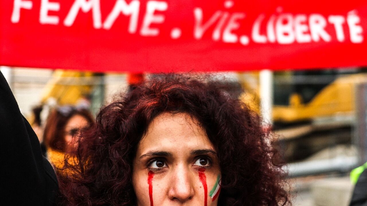 A protestor with red tears painted on her face during a rally in support of the demonstrations in Iran, in Toulouse, south-western France, on December 3 A protestor with red tears painted on her face during a rally in support of the demonstrations in Iran, in Toulouse, south-western France, on December 3