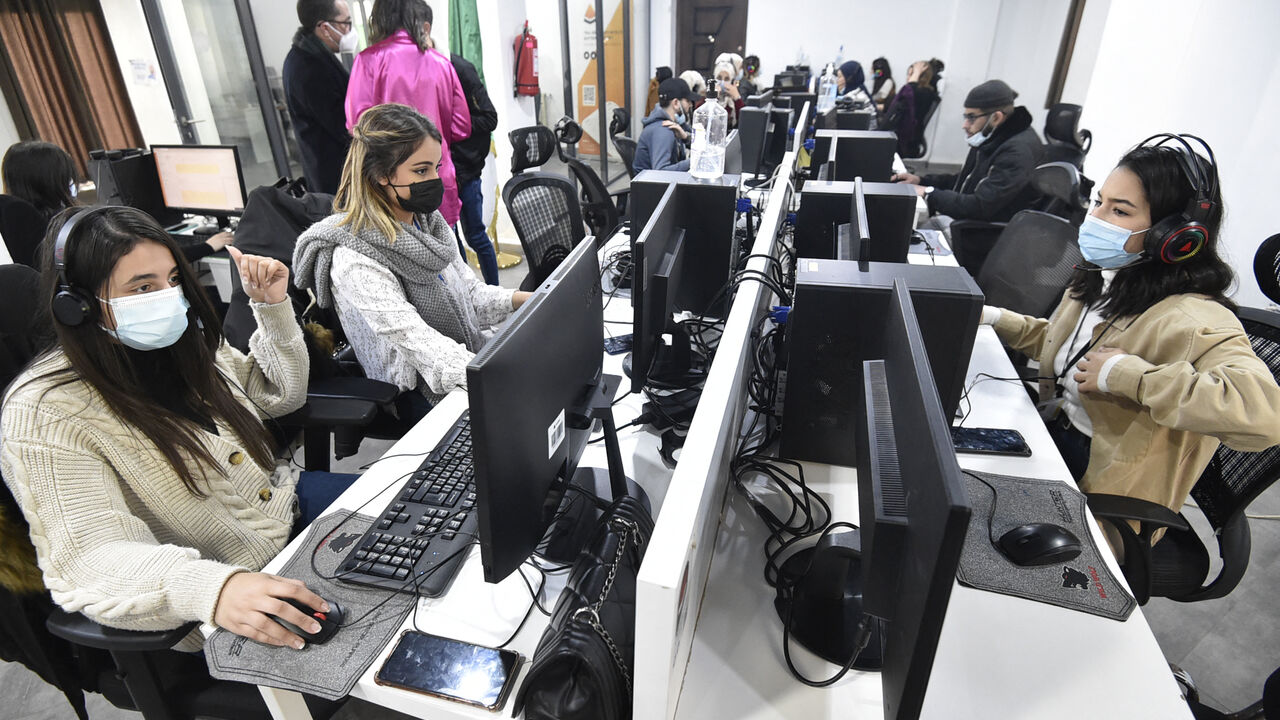 Employees work at the call centre of the Algerian delivery company Yassir, at the company's headquarters , in the capital Algiers on February 23, 2022. - It's the Algerian start-up that made good: despite the country's notoriously complex business climate, taxi and home-delivery firm Yassir has millions of users and is expanding across Africa.