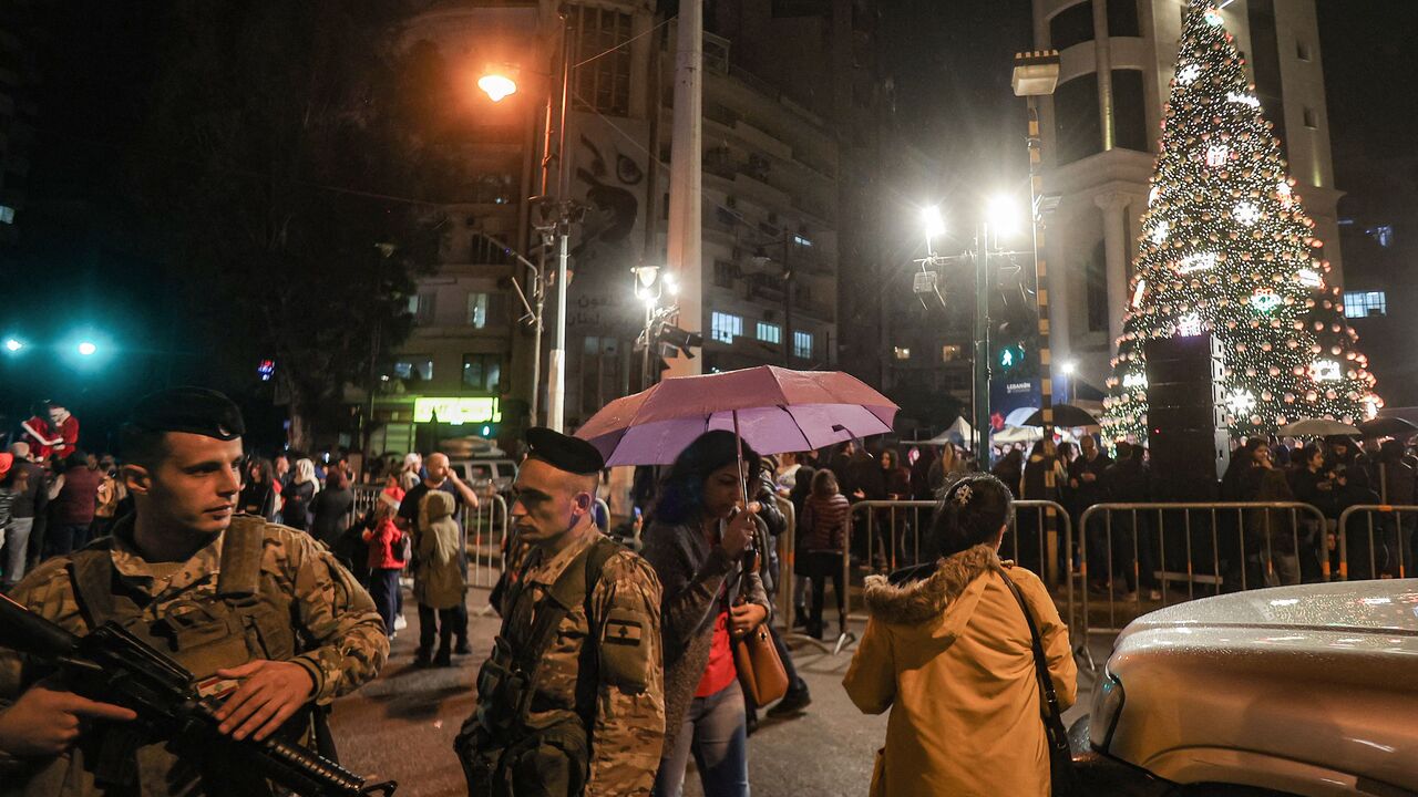 Security forces stand guard during the lighting of the Christmas tree in Sassine Square in the Ashrafieh district of Lebanon's capital Beirut on December 7, 2022. (Photo by ANWAR AMRO/AFP via Getty Images)