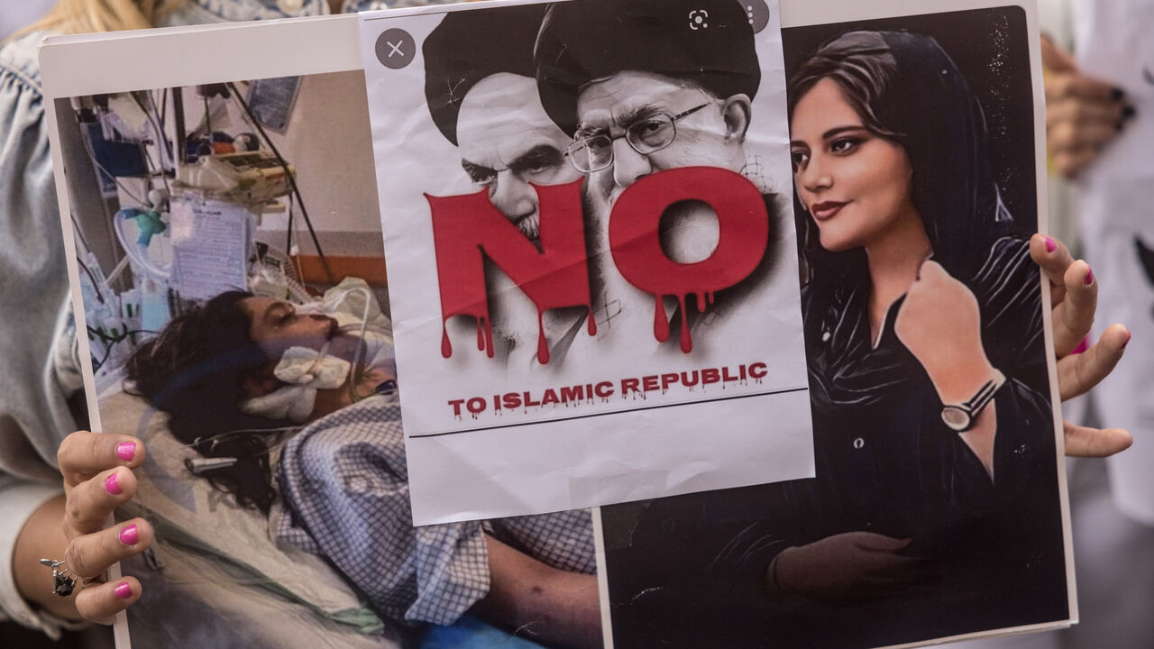 A woman holds a sign during a protest over the death of Iranian Mahsa Amini outside the Iranian Consulate on Oct. 7, 2022 in Istanbul, Turkey.