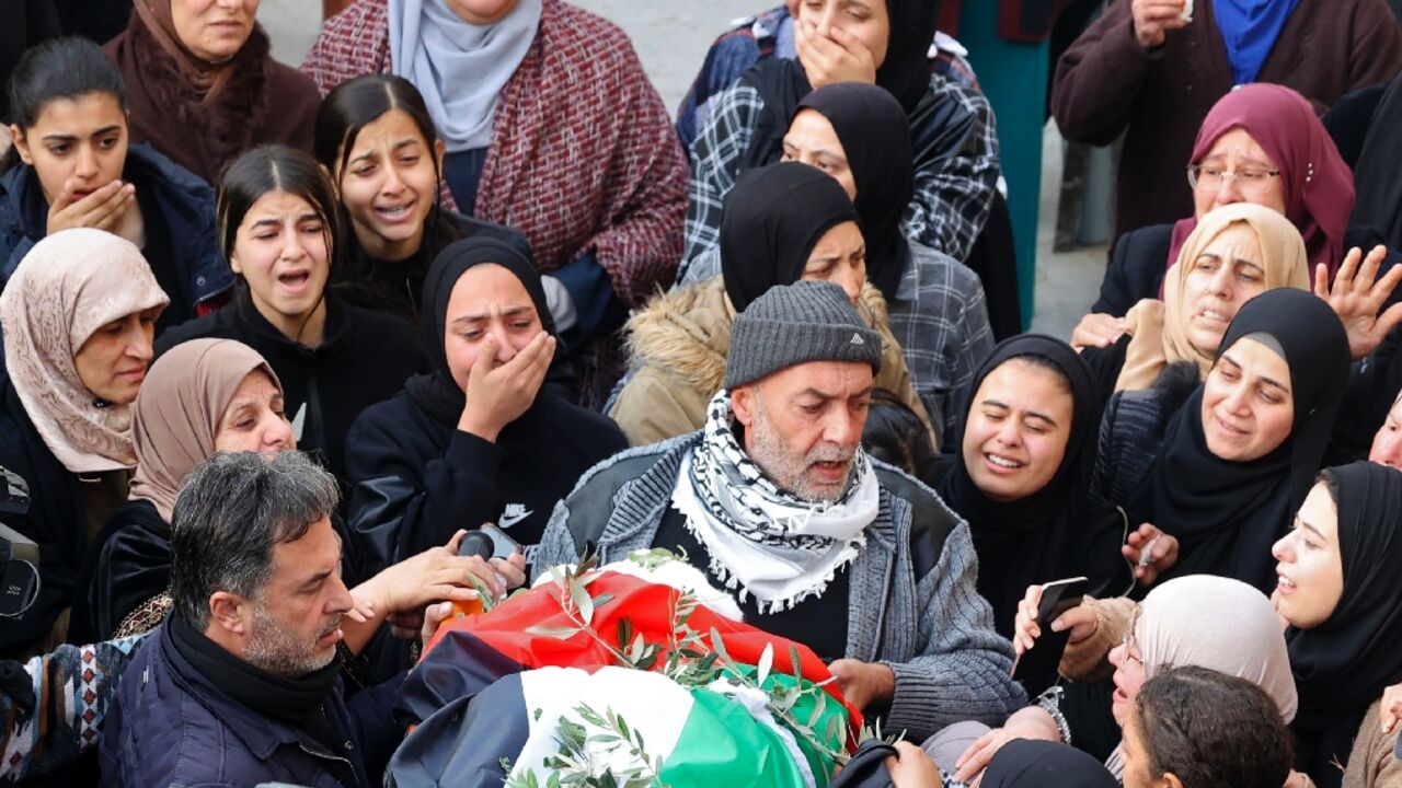 Palestinian mourners attend the funeral of 16-year-old Jana Zakarnaa, killed during an Israeli raid on Sunday night