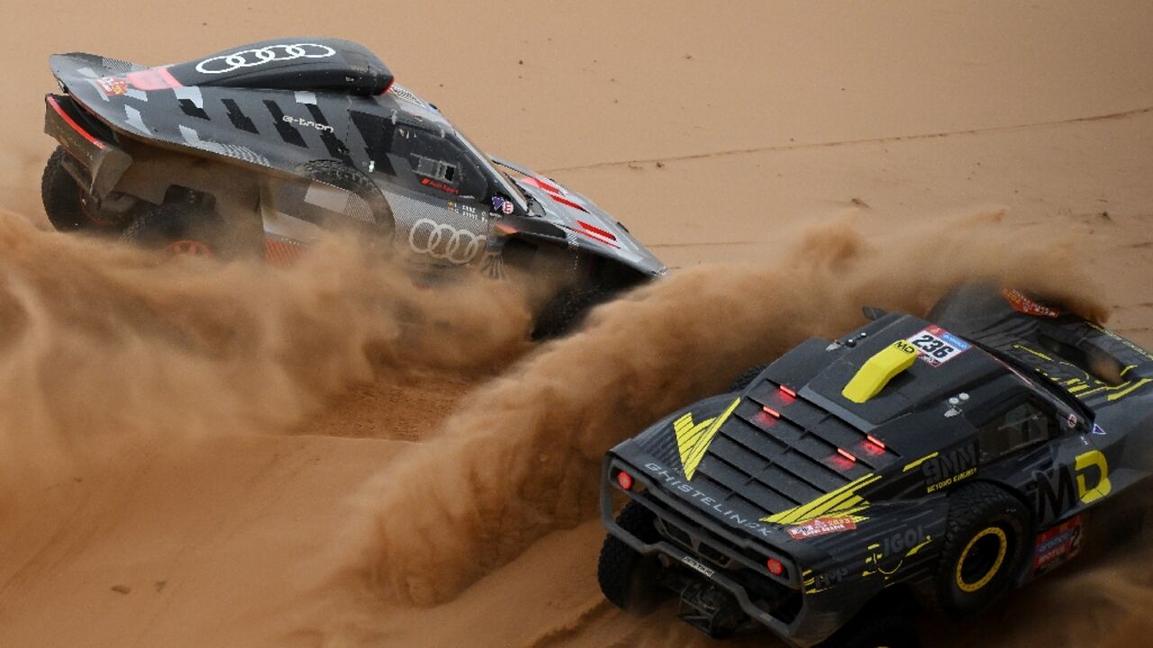Carlos Sainz in his Audi passing Simon Vitse on the eight stage of the Dakar Rally Carlos Sainz in his Audi passing Simon Vitse on the eight stage of the Dakar Rally