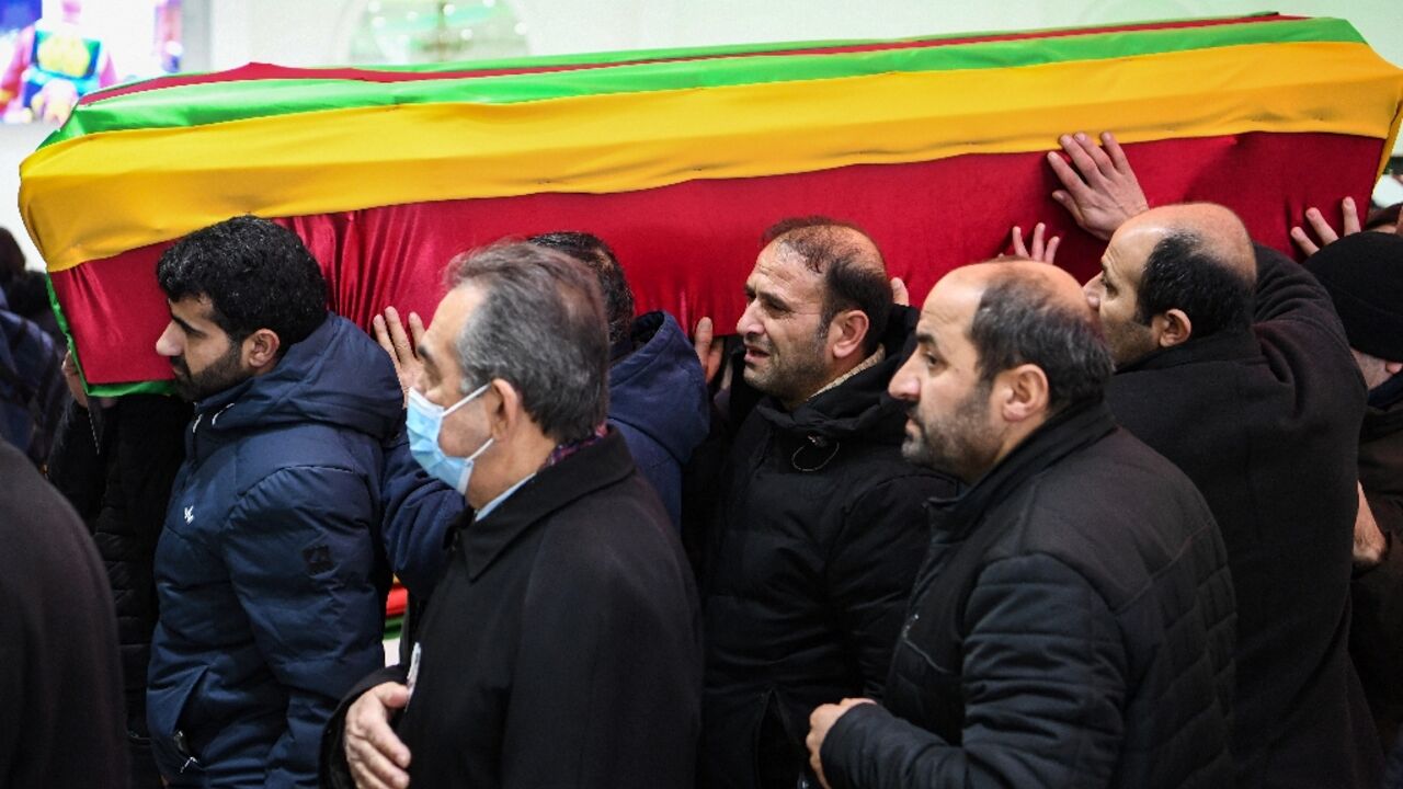 The coffins of the victims were draped in flags of Kurdish political causes The coffins of the victims were draped in flags of Kurdish political causes