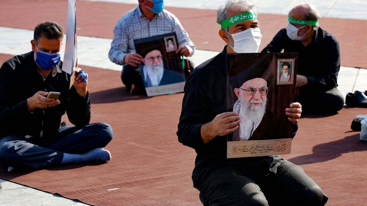 Men hold pictures of the Iranian Supreme Leader Ayatollah Ali Khamenei , during a protest against the reprinting of the cartoon of the Prophet Mohammad by French magazine Charlie Hebdo, at the Imam Hussein square in the capital Tehran, on September 10, 2020. (Photo by -/AFP via Getty Images)