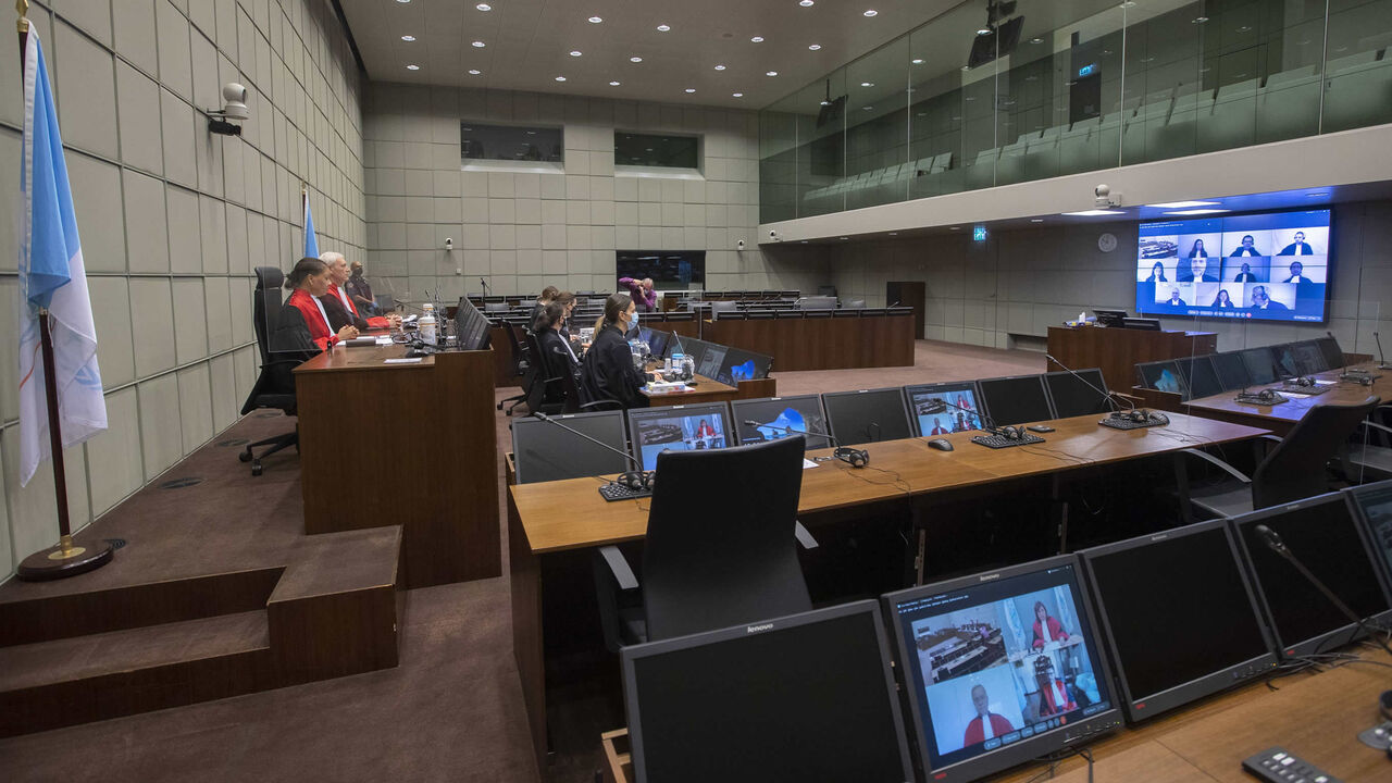 Judges David Re (2nd L) and Janet Nosworthy (L) are seen before the start of the session of the Special Tribunal for Lebanon, where the sentence was set for Salim Jamil Ayyash, a member of the Hezbollah militant group who was convicted of involvement in the assassination of former Lebanese Prime Minister Rafik Hariri and 21 others in 2005, Leidschendam, the Netherlands, Dec. 11, 2020.