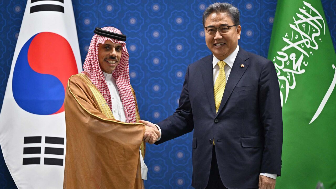 South Korean Foreign Minister Park Jin (R) shakes hands with Saudi Foreign Minister Prince Faisal bin Farhan (L)