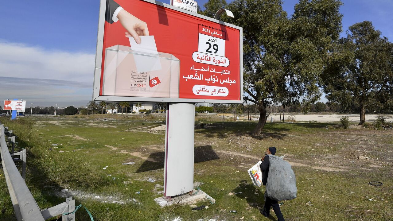 A man walks past an electoral billboard for the Tunisian national election scheduled for January 29, in Tunisia's capital Tunis, on January 25, 2023. (Photo by FETHI BELAID/AFP via Getty Images)