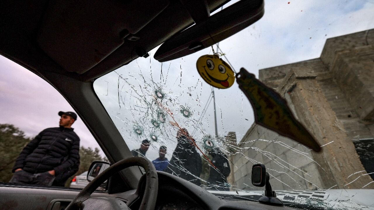Onlookers surround a bullet-riddled car in which two Palestinians were reportedly killed by Israeli troops in Jaba near the West Bank town of Jenin Onlookers surround a bullet-riddled car in which two Palestinians were reportedly killed by Israeli troops in Jaba near the West Bank town of Jenin
