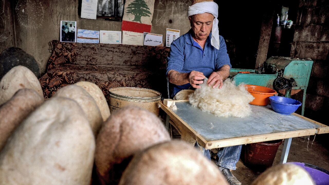 Hatmaker Youssef Akiki prepares to shape one of his traditional "labbadeh" caps with olive soap at his workshop in the mountain village of Hrajel Hatmaker Youssef Akiki prepares to shape one of his traditional "labbadeh" caps with olive soap at his workshop in the mountain village of Hrajel