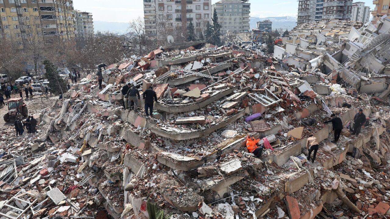 Civilians look for survivors under the rubble of collapsed buildings in Kahramanmaras, close to the quake's epicentre