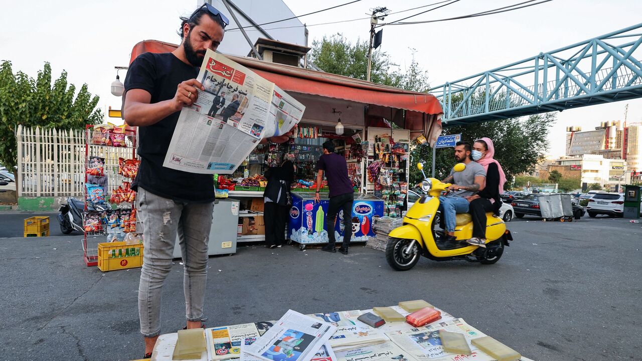 A man reads the Iranian newspaper Etemad, with the front page title reading in Farsi "The night of the end of the JCPOA ", and cover photos of Iran's Foreign Minister Hossein Amir-Abdollahian and his deputy and chief nuclear negotiator Ali Bagheri Kani, in the capital Tehran on Aug. 16, 2022.