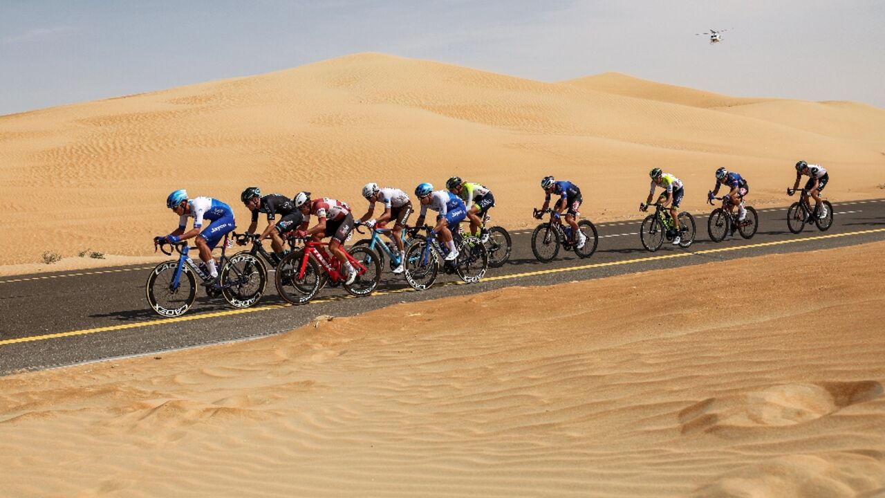 The peloton rides during the first stage of the UAE Tour The peloton rides during the first stage of the UAE Tour