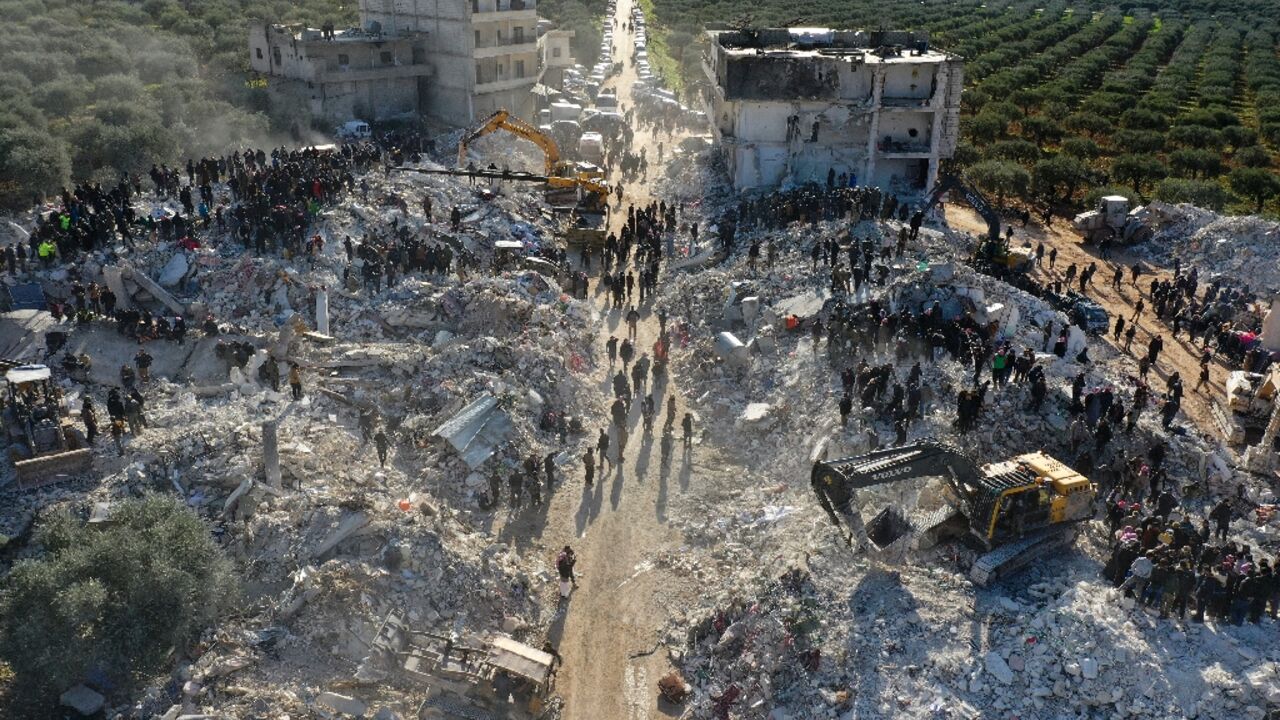 An aerial view of rescuers searching the rubble in the village of Besnaya in northwest Syria