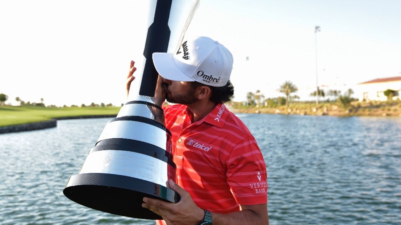 Abraham Ancer celebrates with the trophy after his fourth professional win in the Saudi International 