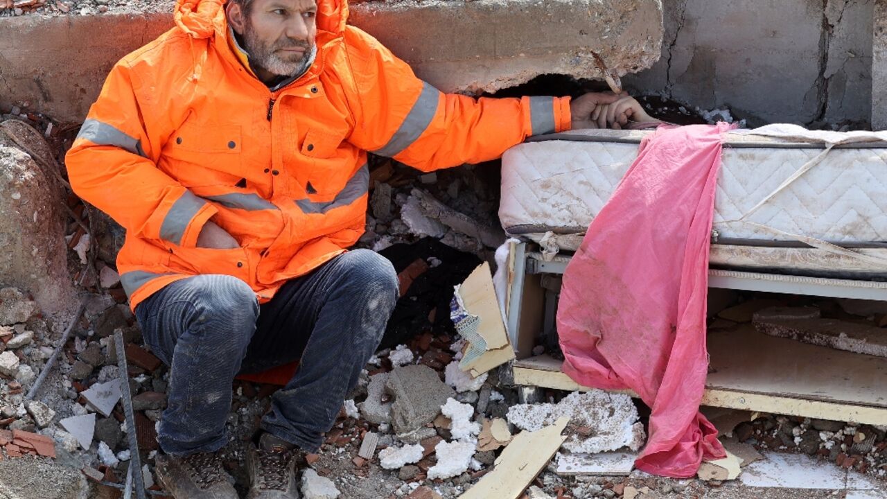 Mesut Hancer holds his dead daughter's hand. Irmak, 15, died in the Turkey-Syria quake