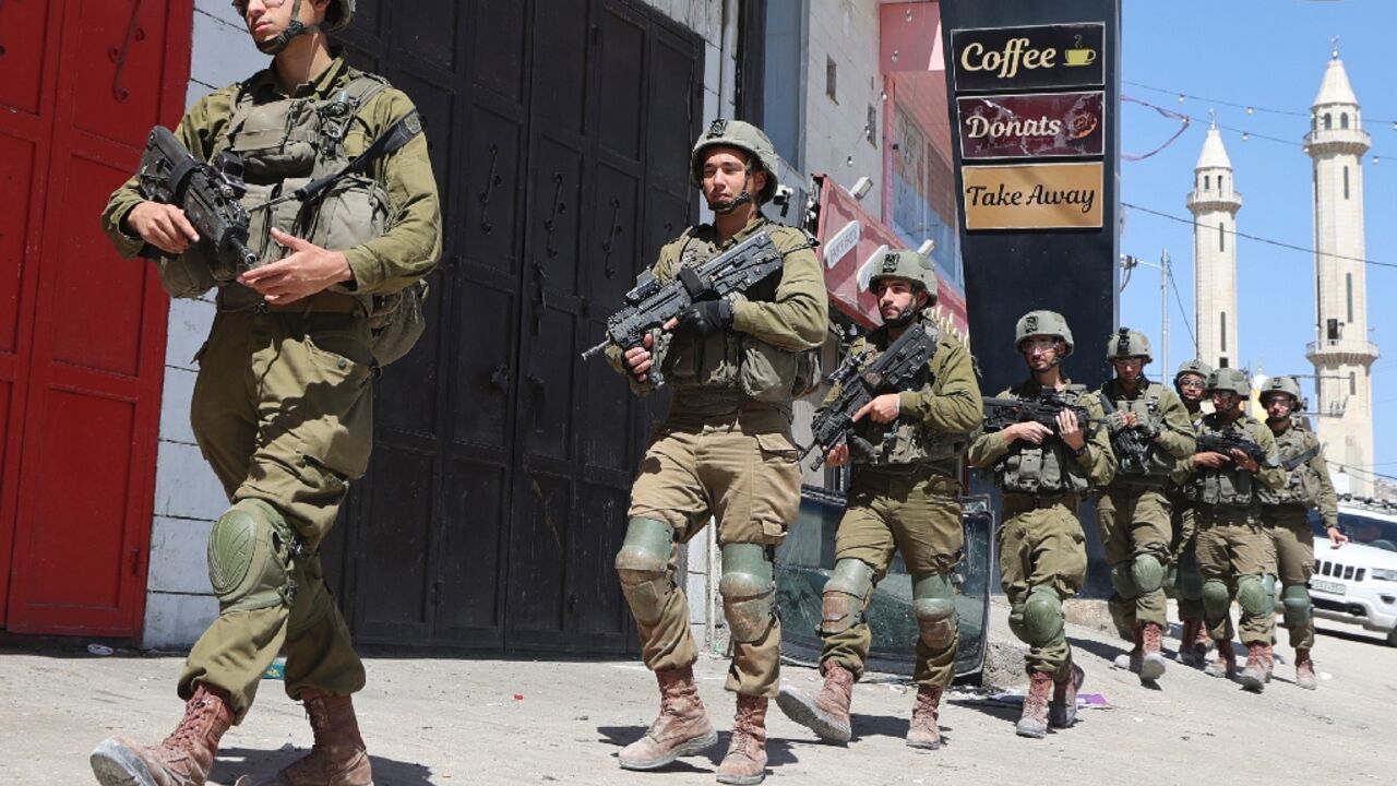 Israeli troops patrol in the occupied-West Bank town of Huwara Israeli troops patrol in the occupied-West Bank town of Huwara