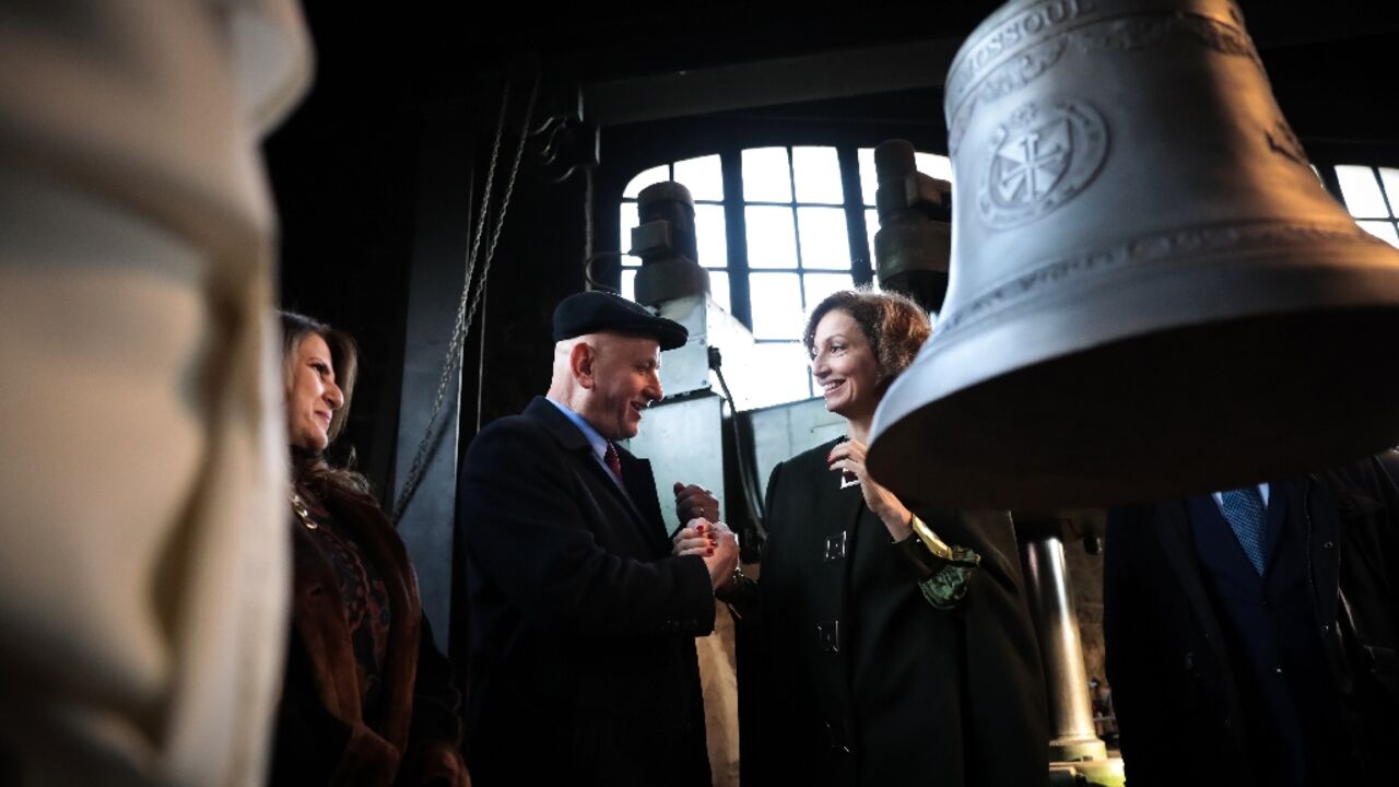 UNESCO Director-General Audrey Azoulay (C) shakes hands with Iraqi ambassador to France Wadee al-Batti on December 5, 2022 at the enveiling of a bell for Mosul's Our Lady of the Hour convent UNESCO Director-General Audrey Azoulay (C) shakes hands with Iraqi ambassador to France Wadee al-Batti on December 5, 2022 at the enveiling of a bell for Mosul's Our Lady of the Hour convent