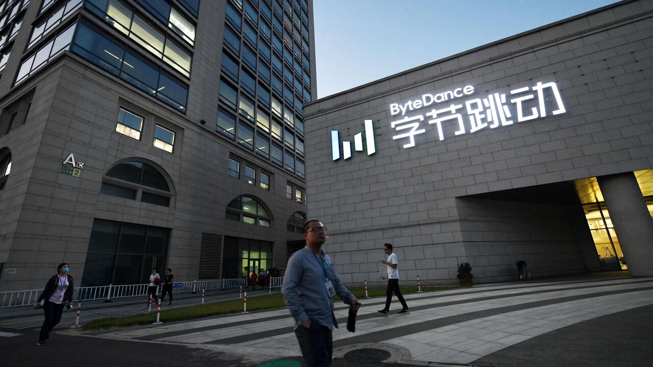 People walk past the headquarters of ByteDance, the parent company of video sharing app TikTok, in Beijing on September 16, 2020. - Silicon Valley tech giant Oracle is "very close" to sealing a deal to become the US partner to Chinese-owned video app TikTok to avert a ban in the United States, President Donald Trump said on September 15. (Photo by GREG BAKER/AFP via Getty Images)