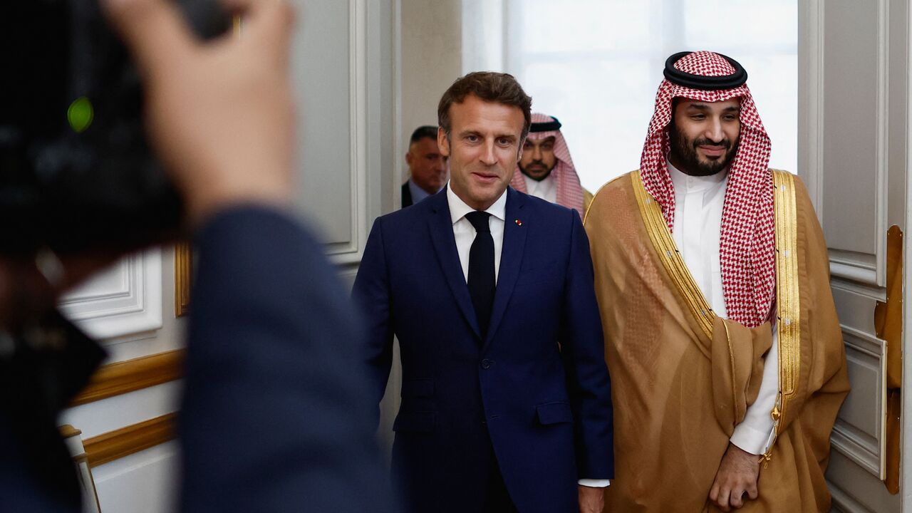 France's President Emmanuel Macron (L) arrives with Saudi Crown Prince Mohammed bin Salman for a working dinner at presidential Elysee Palace in Paris on July 28, 2022. - French President Emmanuel Macron host Saudi Arabia's Crown Prince Mohammed bin Salman for talks in Paris on July 28, 2022, outraging rights groups and the fiancee of slain Saudi journalist Jamal Khashoggi. (Photo by BENOIT TESSIER / POOL / AFP) (Photo by BENOIT TESSIER/POOL/AFP via Getty Images)