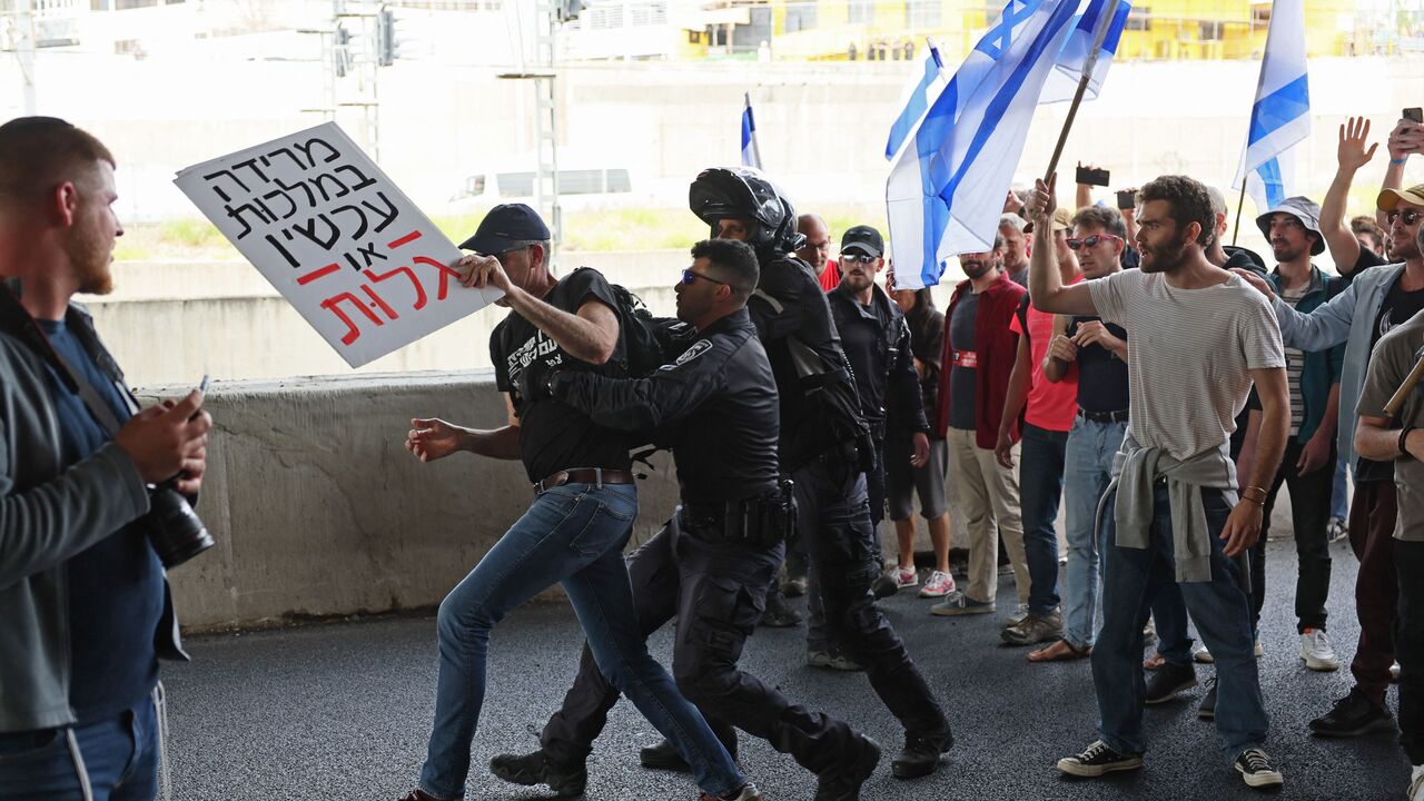 Israeli police confront protesters during ongoing demonstrations in Tel Aviv on March 23, 2023, against controversial legal reforms being touted by the country's hard-right government. - Israel's ruling coalition presented an amended version of a key element in its contentious judicial overhaul, in hopes of allaying concerns at home and abroad for Israeli democracy. (Photo by JACK GUEZ / AFP) (Photo by JACK GUEZ/AFP via Getty Images)