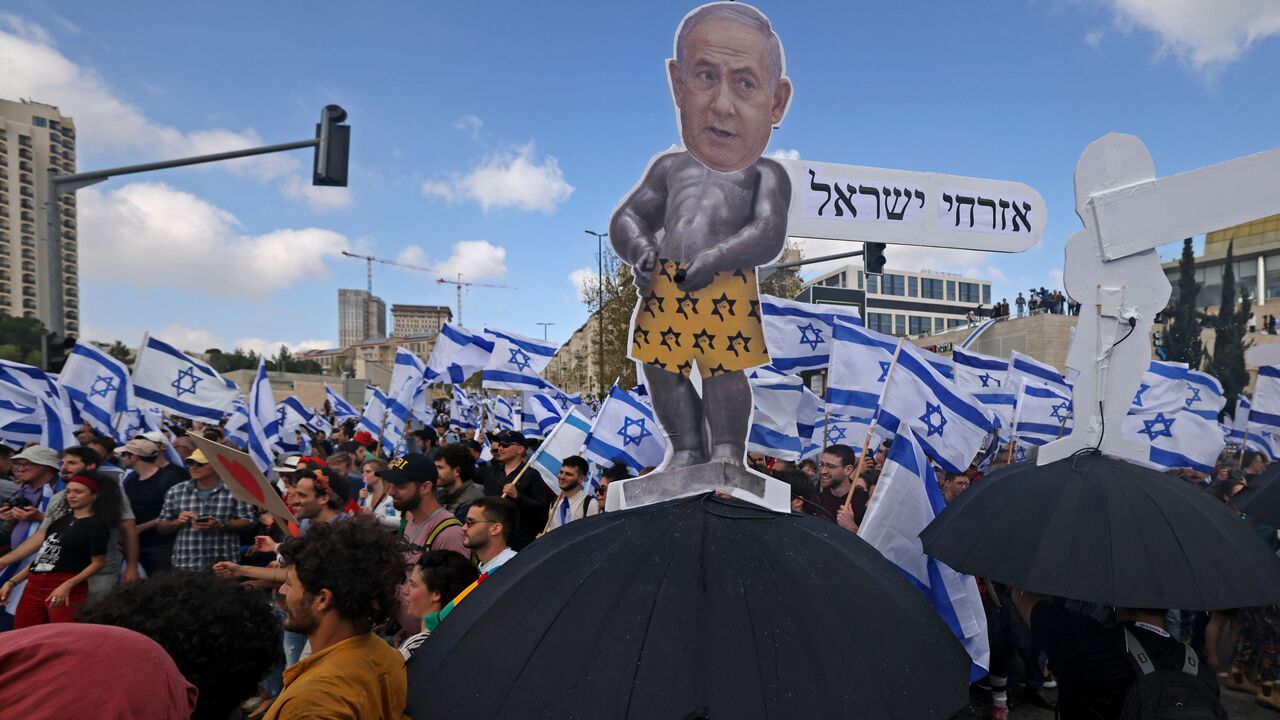 rotesters gather outside Israel's parliament in Jerusalem amid ongoing demonstrations and calls for a general strike against the hard-right government's controversial push to overhaul the justice system, on March 27, 2023. (Photo by AHMAD GHARABLI / AFP) (Photo by AHMAD GHARABLI/AFP via Getty Images)