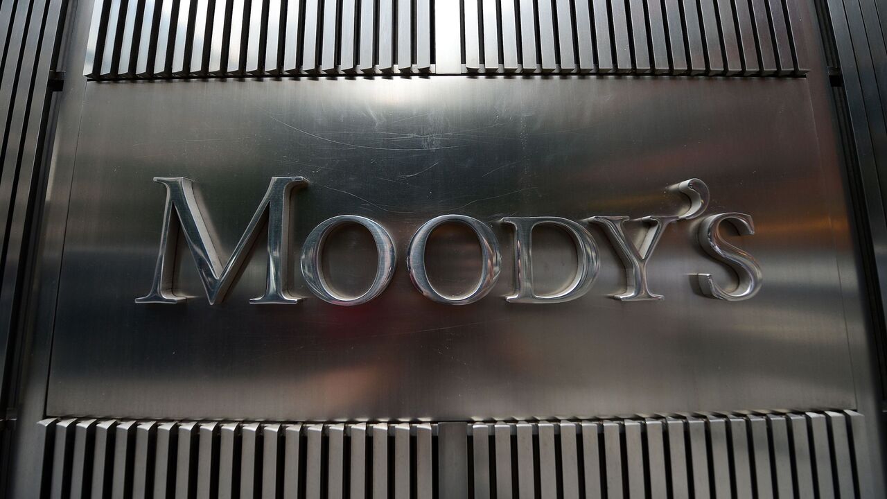 A sign for Moody's rating agency is displayed at the company headquarters in New York, on Sept. 18, 2012. 