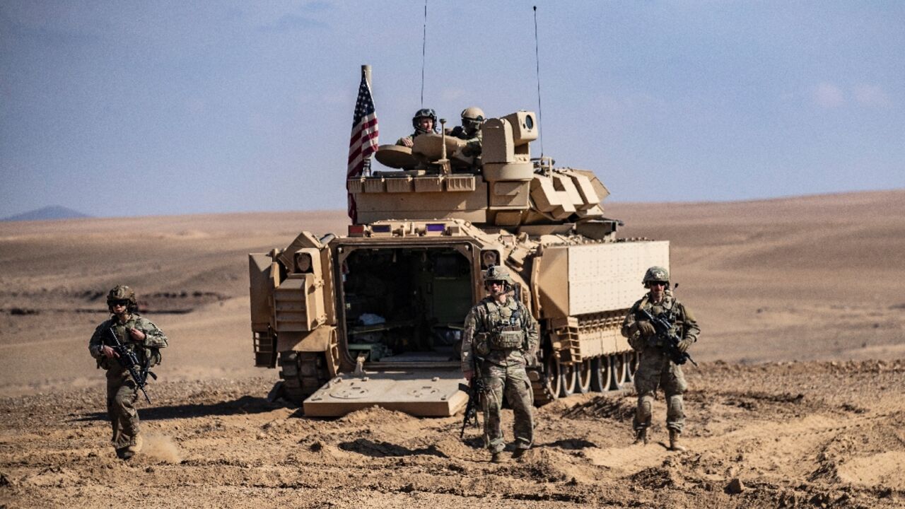 Troops from the Syrian Democratic Forces (SDF) and the US-led anti-jihadist coalition, take part in exercises in Syria near Deir Ezzor on March 25, 2022 Troops from the Syrian Democratic Forces (SDF) and the US-led anti-jihadist coalition, take part in exercises in Syria near Deir Ezzor on March 25, 2022