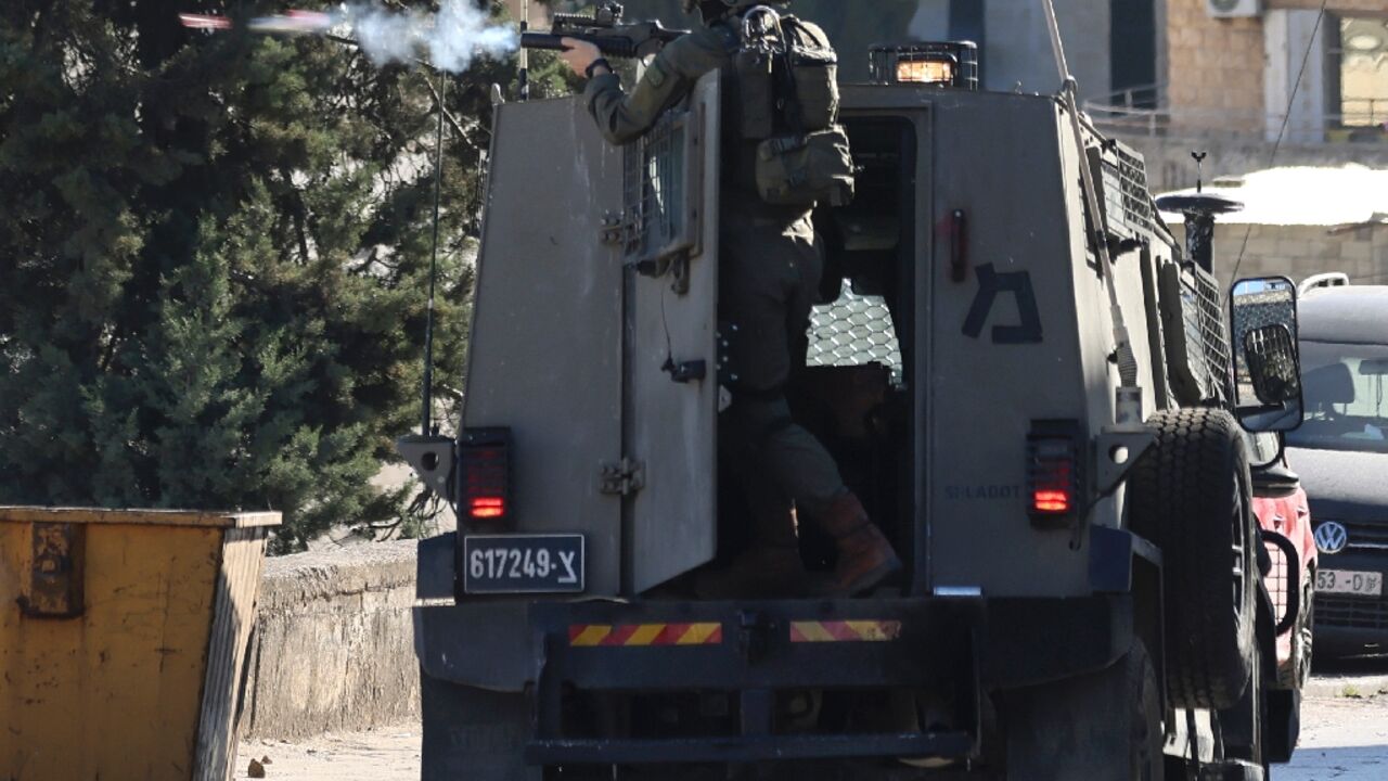 An Israeli soldier fires a projectile during clashes in the city of Nablus in the occupied West Bank An Israeli soldier fires a projectile during clashes in the city of Nablus in the occupied West Bank