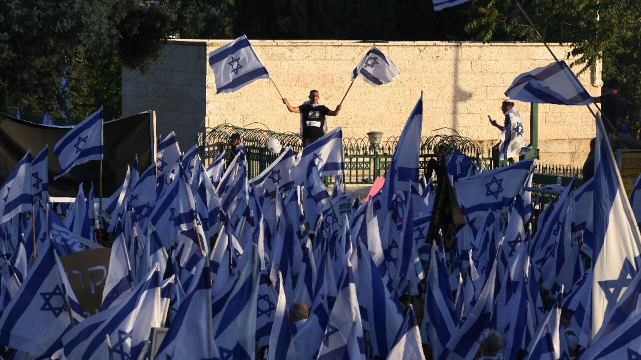 Pro-government protesters gather near Israel's parliament in Jerusalem on April 27, 2023 in support of the hard-right government's controversial push to overhaul the justice system Pro-government protesters gather near Israel's parliament in Jerusalem on April 27, 2023 in support of the hard-right government's controversial push to overhaul the justice system