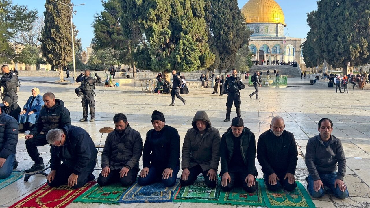 Israeli security forces stand guard as Palestinians pray in Jerusalem's al-Aqsa Mosque compound after officers earlier stormed the mosque's prayer hall Israeli security forces stand guard as Palestinians pray in Jerusalem's al-Aqsa Mosque compound after officers earlier stormed the mosque's prayer hall