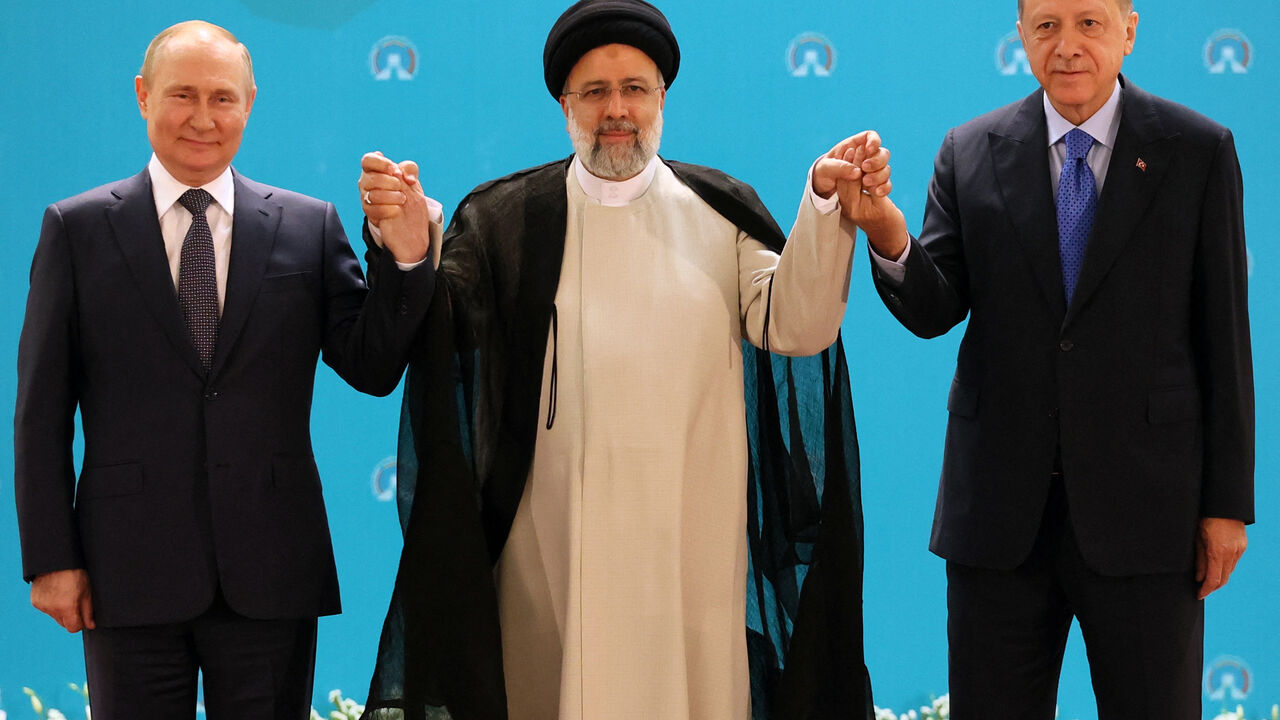 (L-R) Russian President Vladimir Putin, Iranian President Ebrahim Raisi and Turkish President Recep Tayyip Erdogan pose for a photo before a trilateral meeting on Syria in Tehran on July 19, 2022. (Photo by Sergei SAVOSTYANOV / SPUTNIK / AFP) (Photo by SERGEI SAVOSTYANOV/SPUTNIK/AFP via Getty Images)