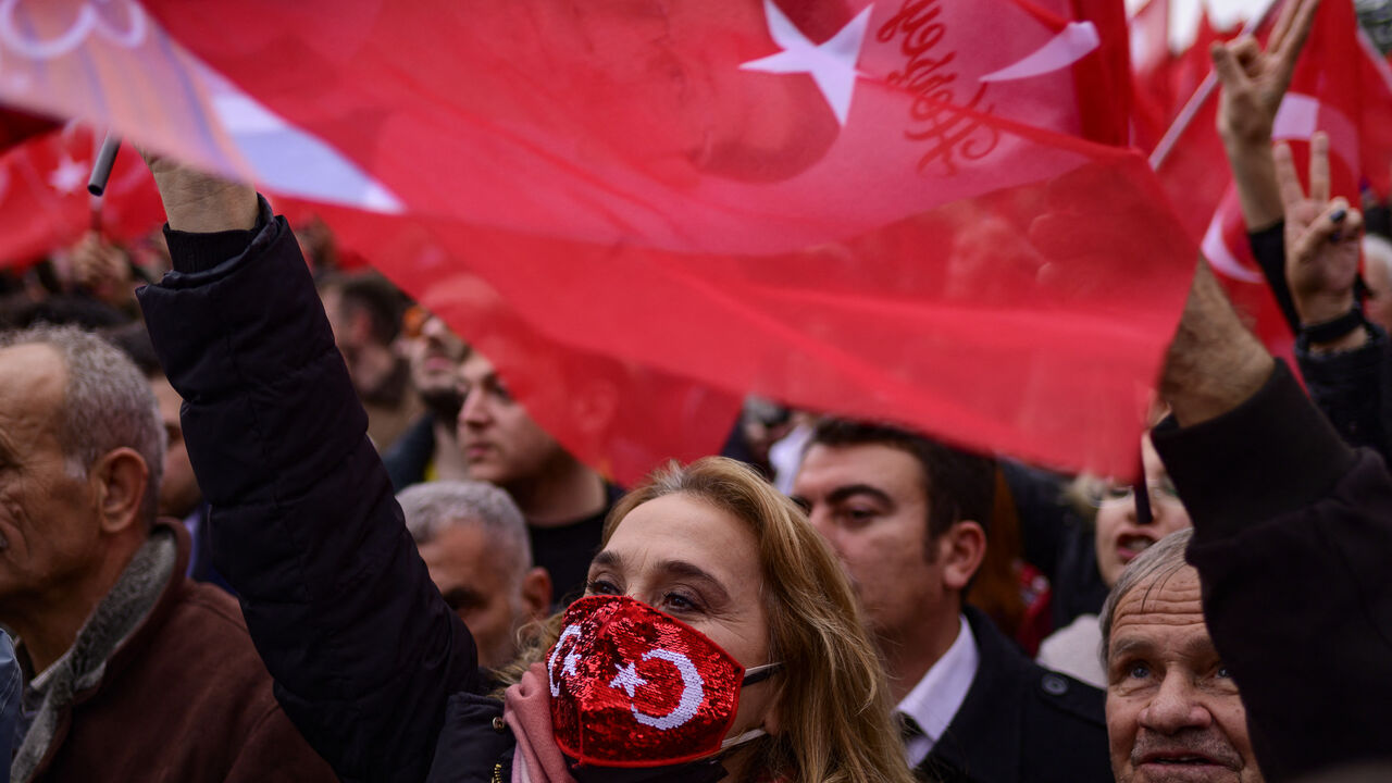 Supporters of Istanbul Mayor Ekrem Imamoglu wave national flags as they gather in front of the Istanbul Metropolitan Municipality during a protest in Istanbul on December 15, 2022, after a Turkish court sentenced him to more than two years jail and banned him from politics ahead of next year's presidential election. (Photo by Yasin AKGUL / AFP) (Photo by YASIN AKGUL/AFP via Getty Images)