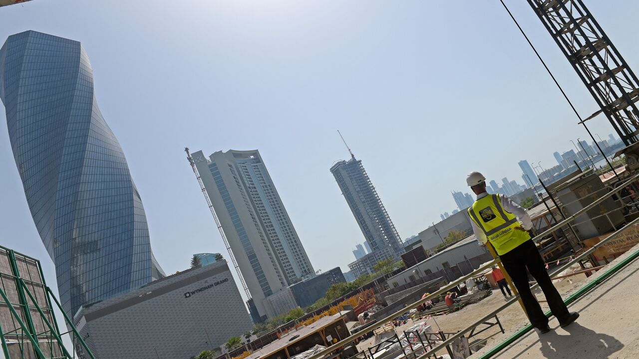 Workers work on the construction site of the Golden Gate towers at Bahrain Bay in Manama on March 25, 2023. - With a multi-billion dollar economic revamp in full swing, tiny Bahrain is vying to keep pace with its Gulf neighbours after more than a decade beset by political unrest. (Photo by Mazen Mahdi / AFP) (Photo by MAZEN MAHDI/AFP via Getty Images)