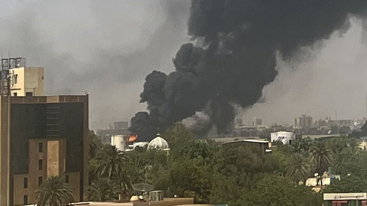 Smoke billows above residential buildings in Khartoum on April 16, 2023, as fighting in Sudan raged for a second week in battles between rival generals. (Photo by -/AFP via Getty Images)