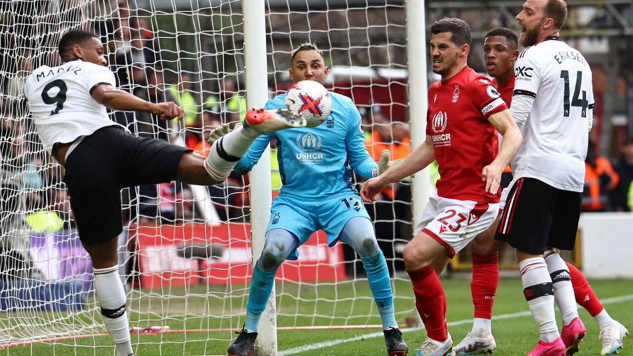 Manchester United's French striker Anthony Martial (L) competes for the ball in the Forest goalmouth during the English Premier League football match between Nottingham Forest and Manchester United at The City Ground in Nottingham, central England, on April 16, 2023. (Photo by DARREN STAPLES / AFP) /