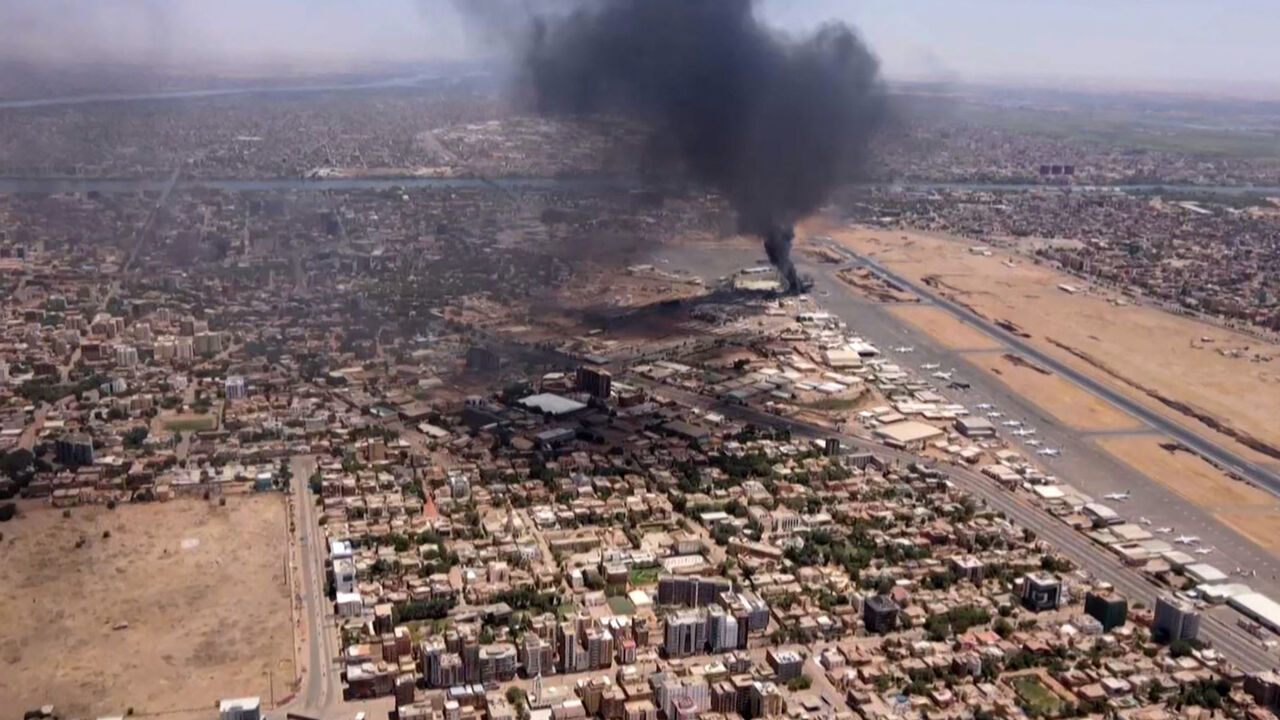 This image grab taken from AFPTV video footage on April 20, 2023, shows an aerial view of black smoke rising above the Khartoum International Airport amid ongoing battles between the forces of two rival generals. 