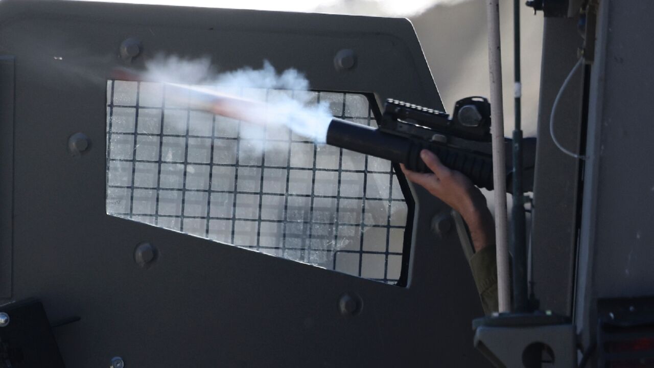 An Israeli soldier fires a projectile during clashes in the city of Nablus in the occupied West Bank, following a raid by Israeli forces.