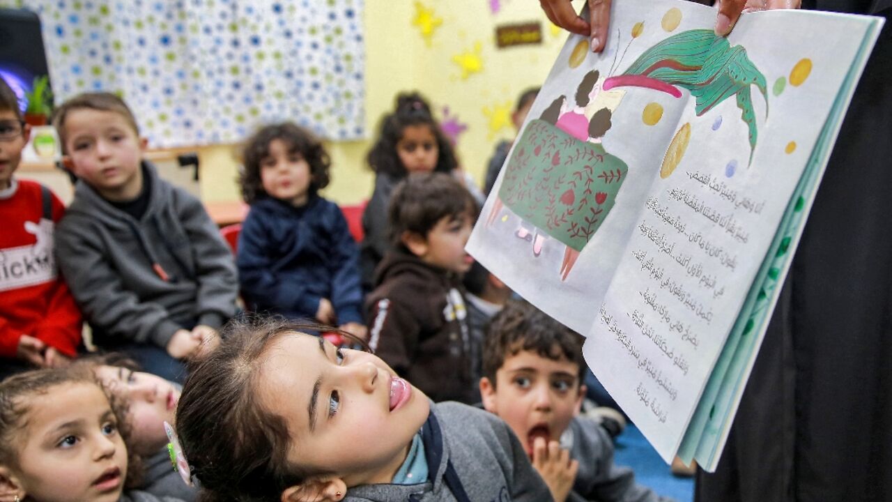 Jordanian teacher Huda Abu al-Khair reads stories to children in a classroom in Amman as part of the "We Love Reading" initiative Jordanian teacher Huda Abu al-Khair reads stories to children in a classroom in Amman as part of the "We Love Reading" initiative
