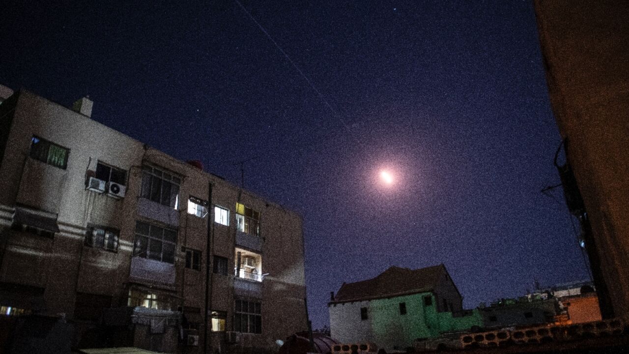 Flares of Syrian air defence rockets are seen in the sky of Damascus early on April 4, 2023 Flares of Syrian air defence rockets are seen in the sky of Damascus early on April 4, 2023